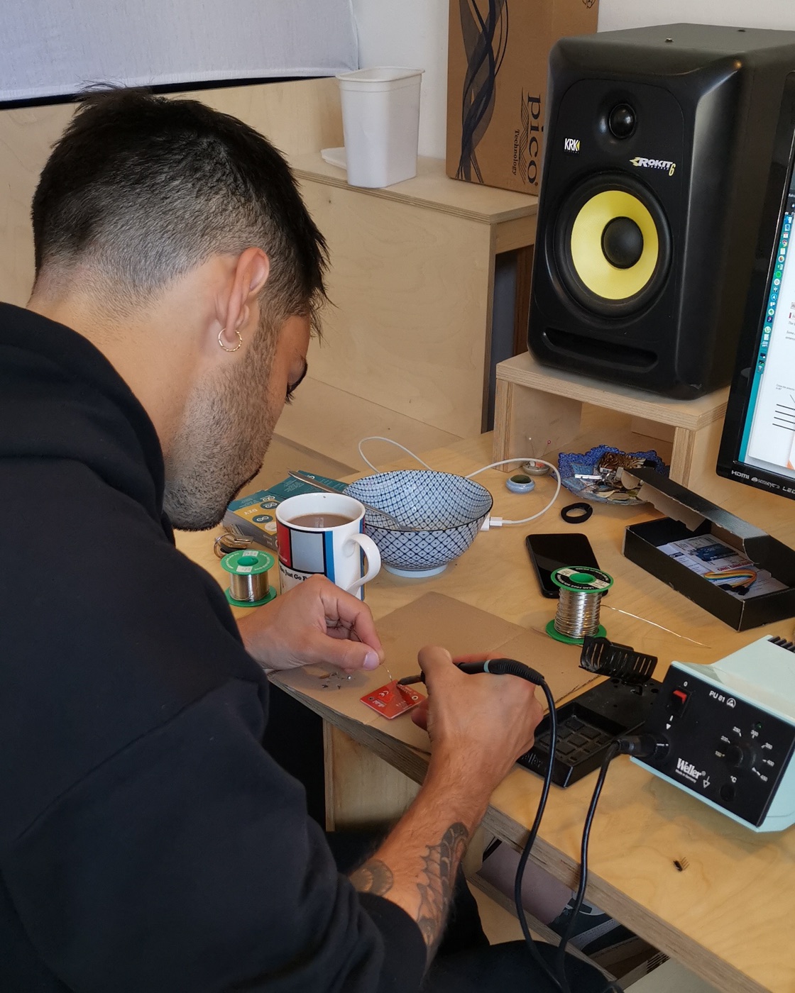 Dennis True, Co-founder of Simplewire, soldering electronics during early prototype work in the Nørrebro apartment